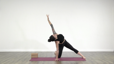 Yogi is practising yoga on a burgundy coloured yoga mat on white background
