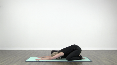 Yogi is practising yoga on a blue yoga mat on white background